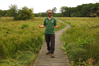 Iain Turbin on a boardwalk through a marsh