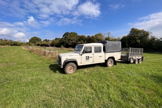 White Land Rover with Worcestershire Wildlife Trust logo on it in a field