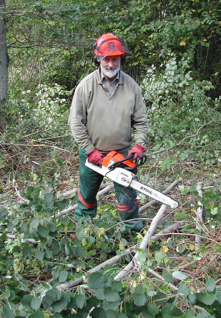 Man with a chainsaw in woodland