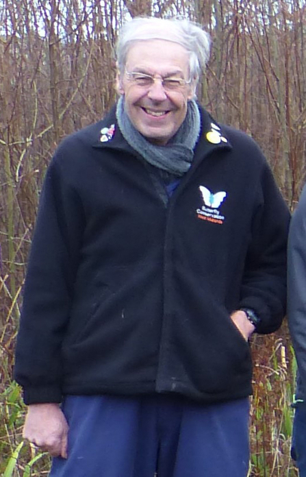 Mike Williams in a Butterfly Conservation logo'd coat in a woodland