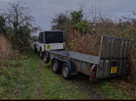 Land Rover and trailer stuck in a hedge