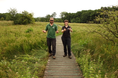 Iain and Romy 'thumbs-up' posing for the camera on the boardwalk at Ipsley Alders Marsh (by Andy Bucklitch)