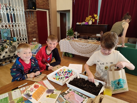 Children making bee bags at the Greener Roots Festival by Beccy Somers