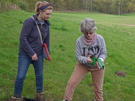 Two women checking a green small mammal trap by Catharine Jarvis