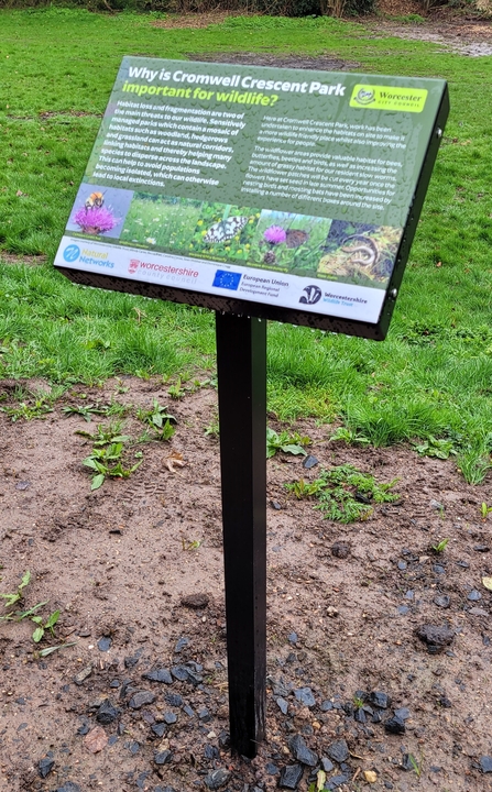 An interpretation panel explaining why the site is important for wildlife. It is stuck to a post which has been drilled into the ground.