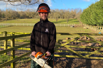 Jake Goodwin holding a chainsaw