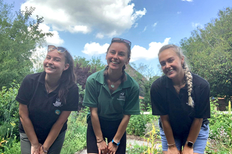 Three trainees smiling at the camera - Amy, Ruthie, Issy