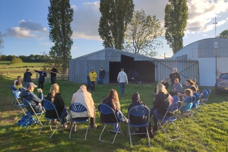 Participants of a dusk chorus walk sitting in a semi-circle before setting off for a walk by Beccy Somers