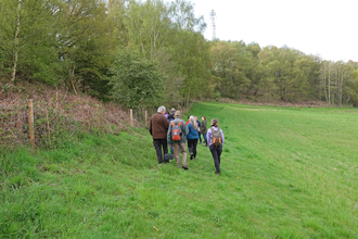 Group of people walking along a field margin by a fence by Catharine Jarvis