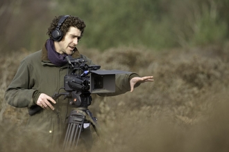Man filming on a nature reserve by Chris Gomersall/2020VISION