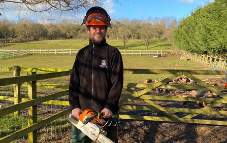 Jake Goodwin holding a chainsaw