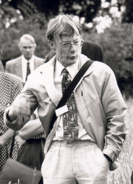 black and white photo of Andrew Fraser in a group of people in a meadow