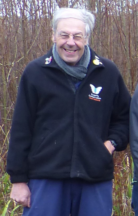 Mike Williams in a Butterfly Conservation logo'd coat in a woodland
