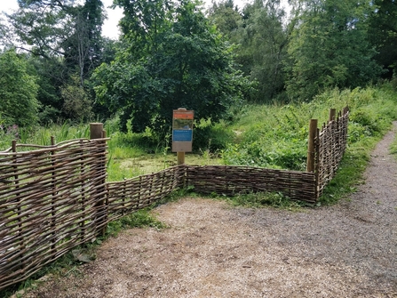 The pond viewing platform with hazel hurdle fencing at The Knapp & Papermill Nature reserve
