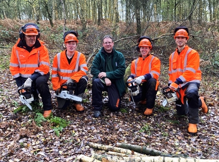 Winter trainee team with chainsaws 