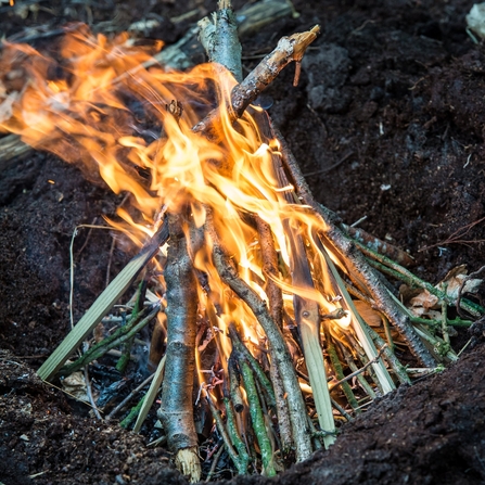 small fire in an earth pit by Matthew Roberts