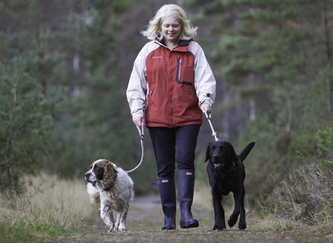 Woman walking two dogs on leads by Peter Cairns/2020VISION