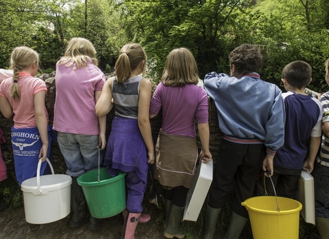 A group of children, with their backs to the camera, standing on a bridge by Ross Hoddinott/2020VISION